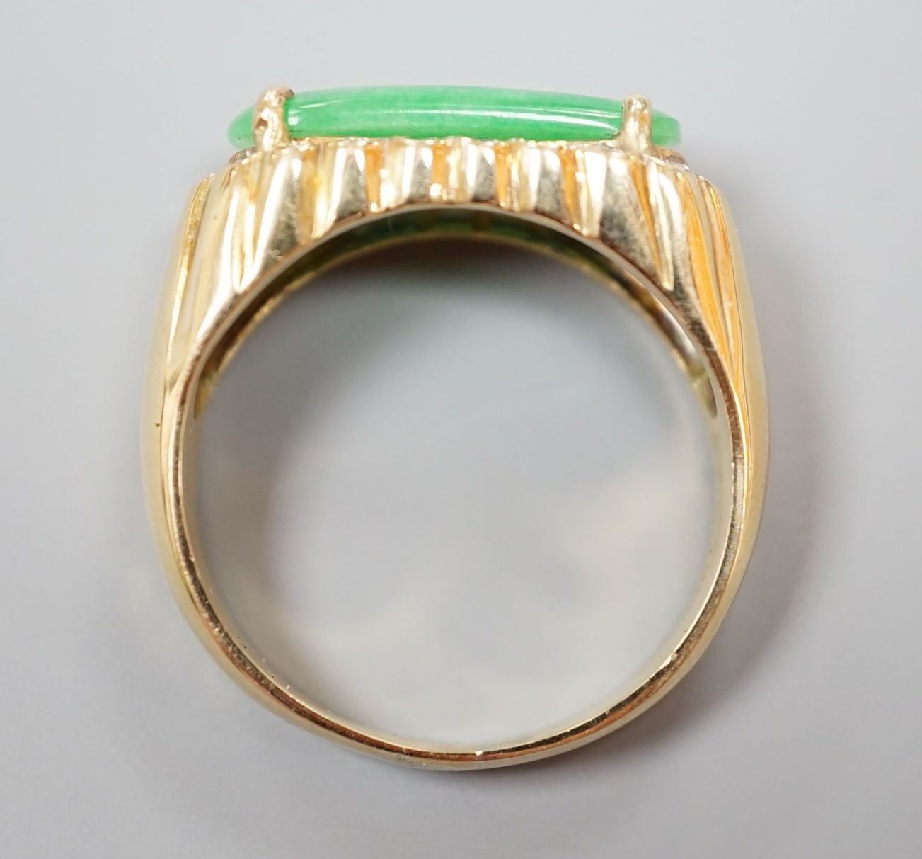 A yellow metal, jadeite and diamond set ovoid dress ring, size T, gross 6.6 grams.